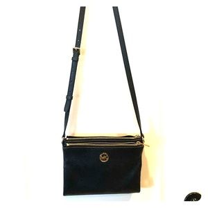 A lighting used Michael Kors purse.